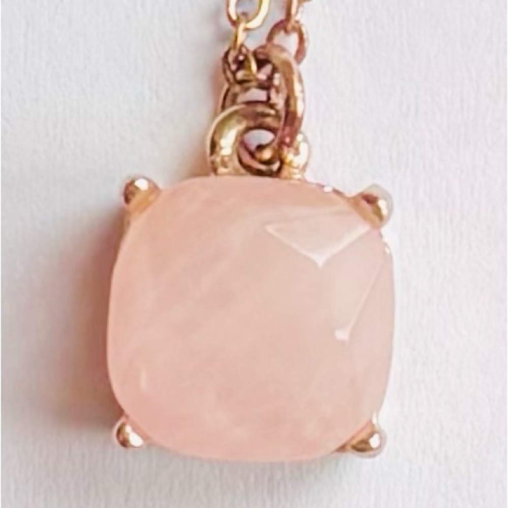 Charming Charlie rose quartz and goldtone pendant.